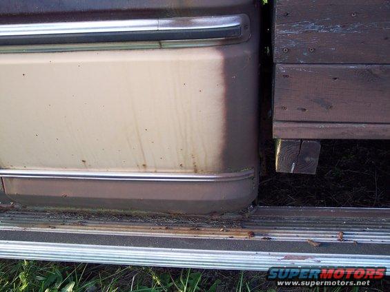 Side view of a tan 1978 Ford F-250 door and running board with chrome trim