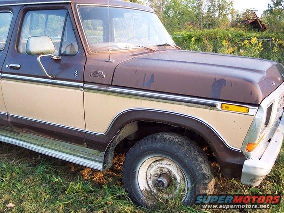 Brown and tan 1978 Ford F-250 pickup truck, front right quarter view, showing rust and wear