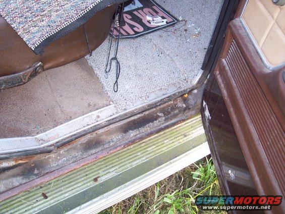 Interior door sill and floor mat with a 'For Sale' sign visible