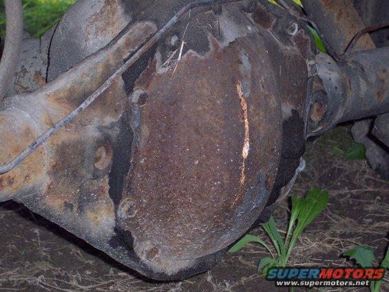 Rusty differential housing with bolts and brake line