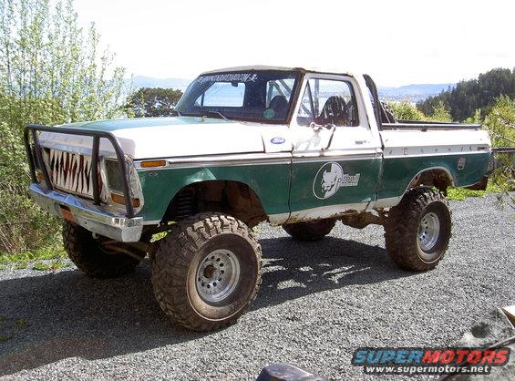 1979 Ford F-150 pickup truck, green and white, with custom grille and lifted suspension