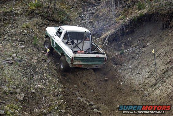 1979 Ford F-150 climbing a steep dirt hill with a roll cage installed