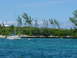 1997 Toyota Land Cruiser - A sailboat is anchored in turquoise waters off a lush, green island under a bright blue sky.