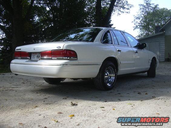 White 1997 Ford Crown Victoria rear 3/4 view. License plate 707-MNM