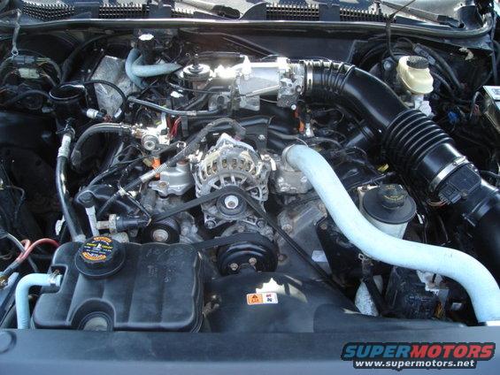 2000 Ford Crown Victoria engine bay with visible alternator, air intake, and coolant reservoir