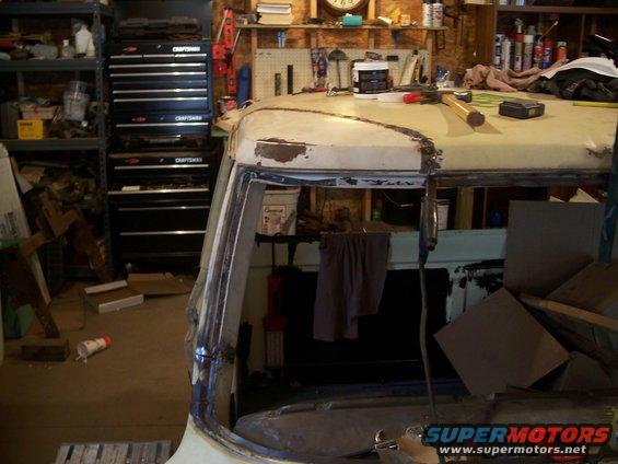 1979 Ford F-150 cab interior showing roofline and window frame, with tool chests in background