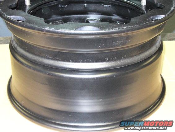 Black steel wheel rim with visible mounting holes and stepped lip