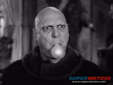 Man with a lightbulb in his mouth, wearing a fur-lined collar. Text at bottom reads SUPERMOTORS