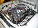 1978 Ford Mustang II - Custom V8 engine in a white vehicle's engine bay, with a glimpse of another car in the background.