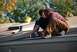1996 Ford Bronco - Two men are working on a roof, with a yellow bucket and tool visible in the background.