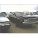 1973 Ford Ranchero - A dark blue Ford Ranchero sits in a junkyard with other vehicles.