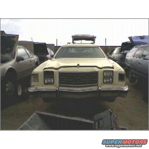 Beige sedan with light bar, front view. Appears to be from the 1970s