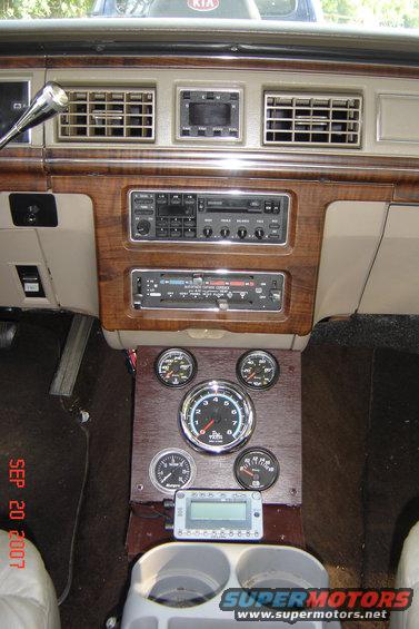 Interior view of custom gauges and dashboard with wood trim