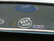 1970 Ford Ranchero - A Ford emblem and various stickers are displayed on the rear window of a vehicle.