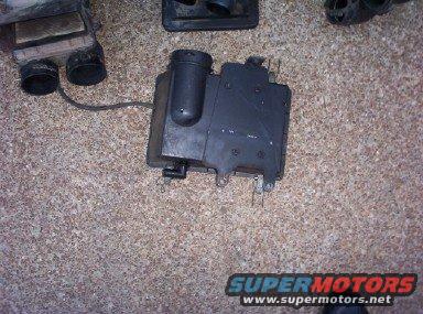 Black airbox assembly with hoses and wires. SuperMotors logo visible