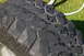 1986 Ford Bronco - A close-up view of a tire's tread pattern, showing its hexagonal blocks and wet surface.
