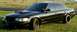 2001 Ford Crown Victoria - A black 2001 Ford Crown Victoria is shown from a three-quarter front angle, custom wheels and a hood scoop.