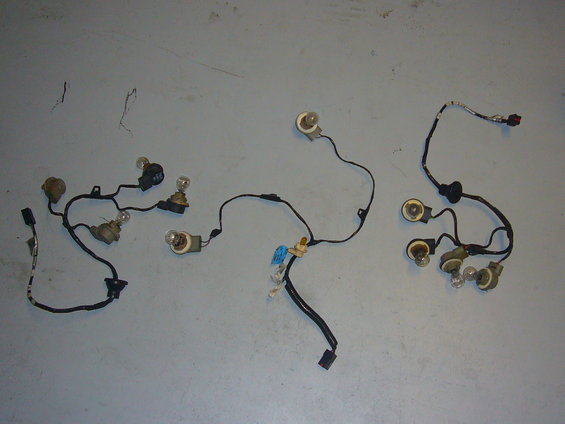 Three separate wiring harnesses with multiple light bulbs and connectors