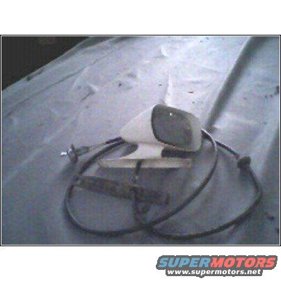 White car side mirror with black cable assembly