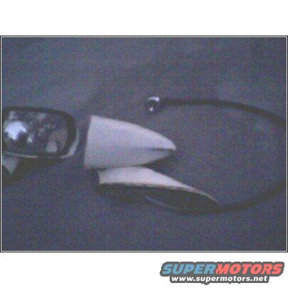 Chrome car mirror and white fender piece with black trim