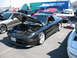 1995 Ford Probe - A black 1995 Ford Probe is displayed with its hood open at an outdoor event, surrounded by other vehicles.