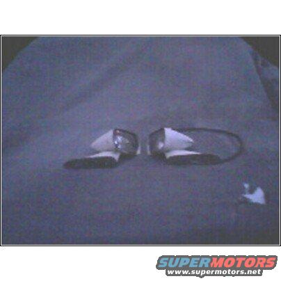 Pair of white side mirrors on a dark background