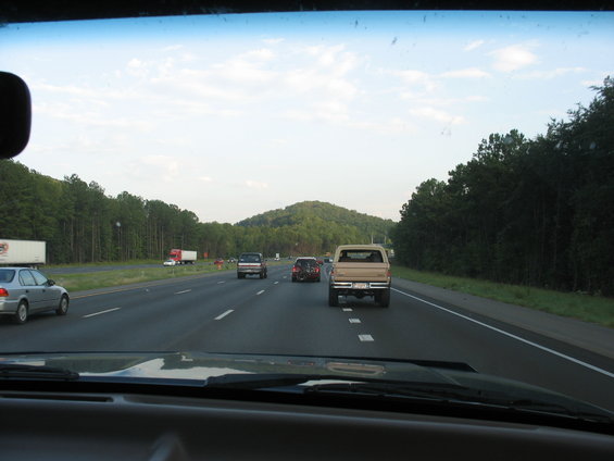 Tan pickup truck from rear on highway, likely 1990s model