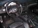2002 BMW M3 - The interior of a 2002 BMW M3 features a leather-wrapped steering wheel and a manual transmission, indicating a driver-focused experience.