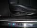 2002 BMW M3 - The M3 badge is visible on the door sill, along with seat memory buttons and part of the driver's seat.