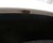 2000 Ford Crown Victoria - A close-up view of a rust spot on the fender lip above a vehicle's wheel well.