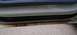 2000 Ford Crown Victoria - The lower door sill of a white vehicle shows significant rust damage.