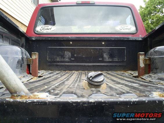 1994 Ford F-250 pickup truck bed with two Ford oval stickers on the rear window