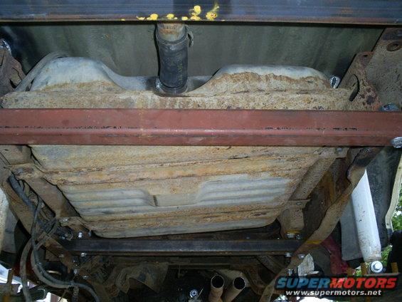 Underside of a 1994 Ford F-250 showing the fuel tank and exhaust pipes