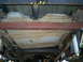 1994 Ford F-250 - The undercarriage of a 1994 Ford F-250 reveals its fuel tank and dual exhaust system.