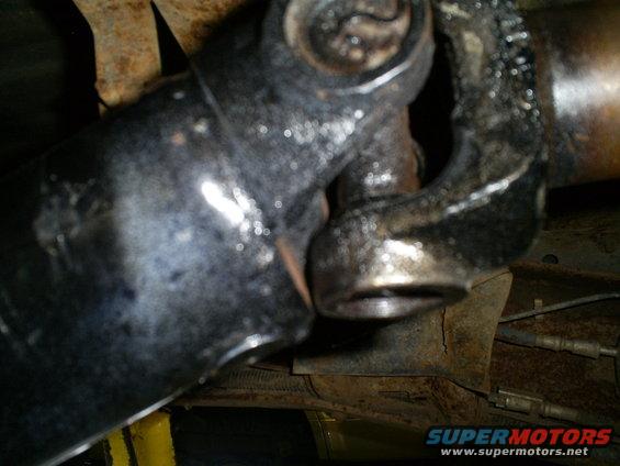 Close-up of a driveshaft universal joint with some grease and rust