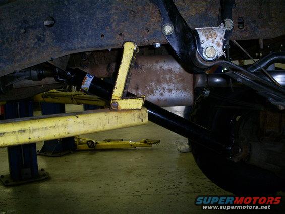 1994 Ford F-250 undercarriage, showing suspension and exhaust system, with a hydraulic jack