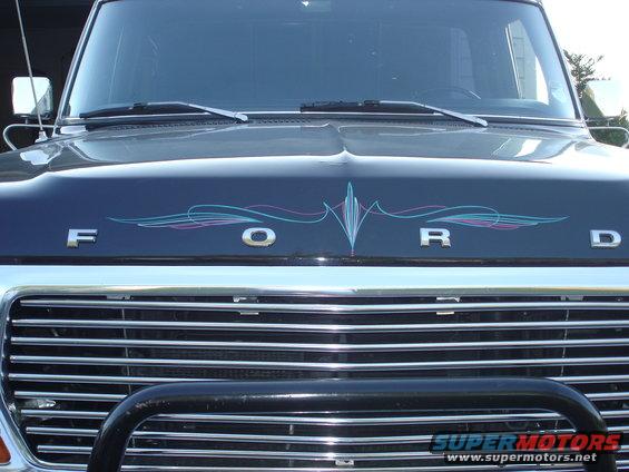 Dark blue Ford F-250 hood with pinstriping and chrome grille