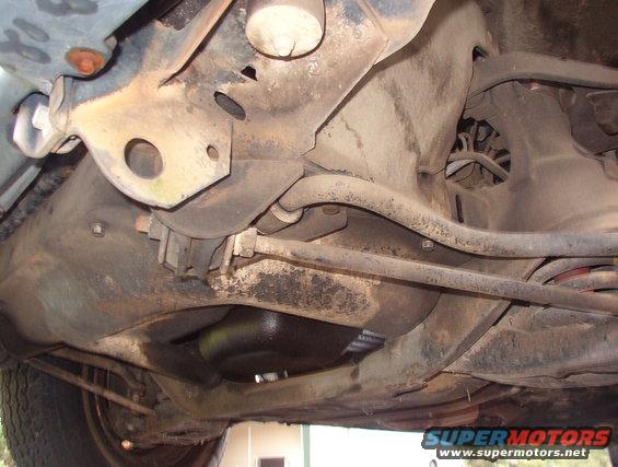 Undercarriage view showing suspension components and exhaust pipe