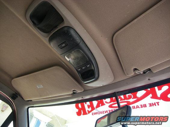Interior overhead console with lights and storage, and beige sun visors