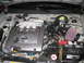 2002 Nissan Maxima - The engine bay of a Nissan Maxima shows the V6 3.5 engine and aftermarket air intake system.