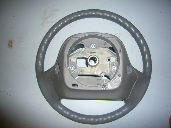 Gray steering wheel with exposed metal column and mounting points