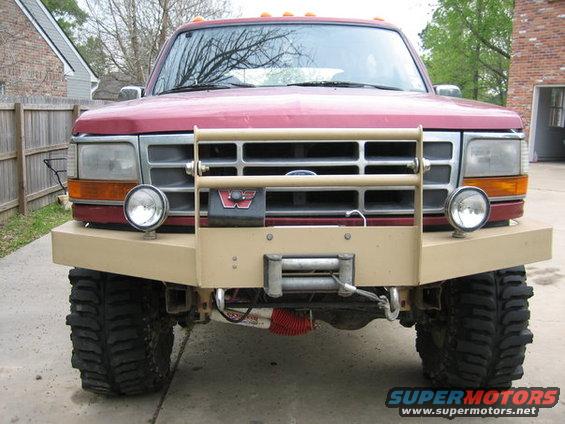 Red 1995 Ford Bronco front view with tan bull bar and winch