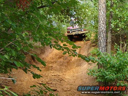 1995 Ford Bronco driving up a muddy hill, 3q-front view