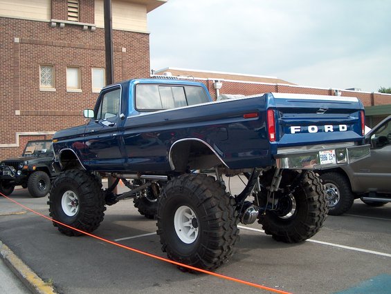 Blue lifted 1978 Ford pickup truck with large tires, rear view