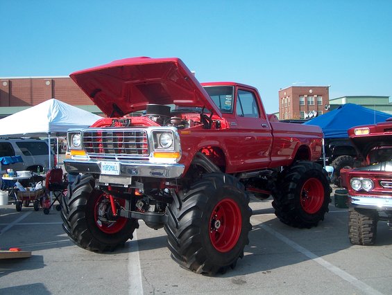 1978 Ford Bronco monster truck, red, hood open, large tires, license plate reads HORSMAII