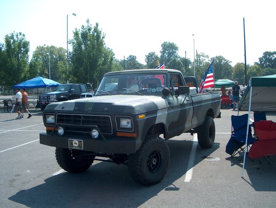 Camouflaged 1978 Ford pickup truck with lifted suspension and American flag