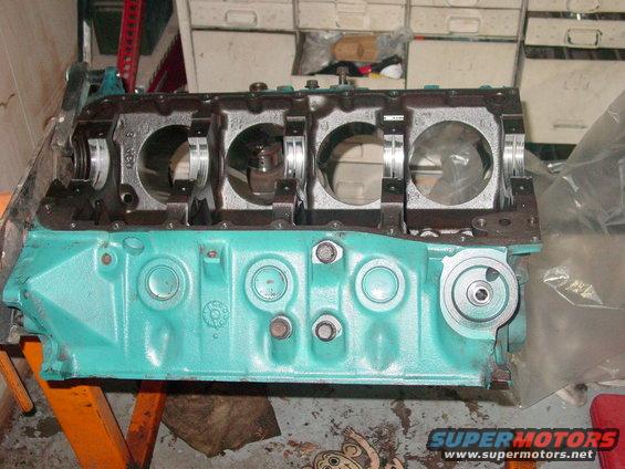 Teal painted engine block with crankshaft bearings visible