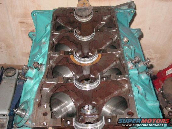 Engine block with crankshaft bearings visible. It's teal on the outside and rusty brown inside