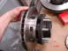 1989 Ford Bronco - A hand holds a brake rotor and hub assembly, with a timestamp of 5 10:09PM visible in the corner.