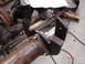 1989 Ford Bronco - Close-up of a vehicle's rear axle assembly, focusing on a newly installed black metal bracket.